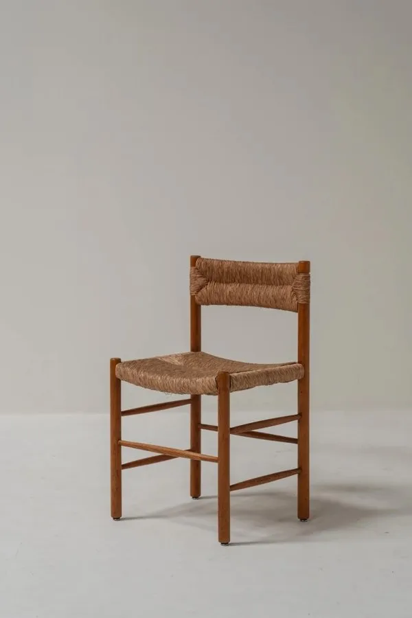 A wooden dining chair with a woven rush seat