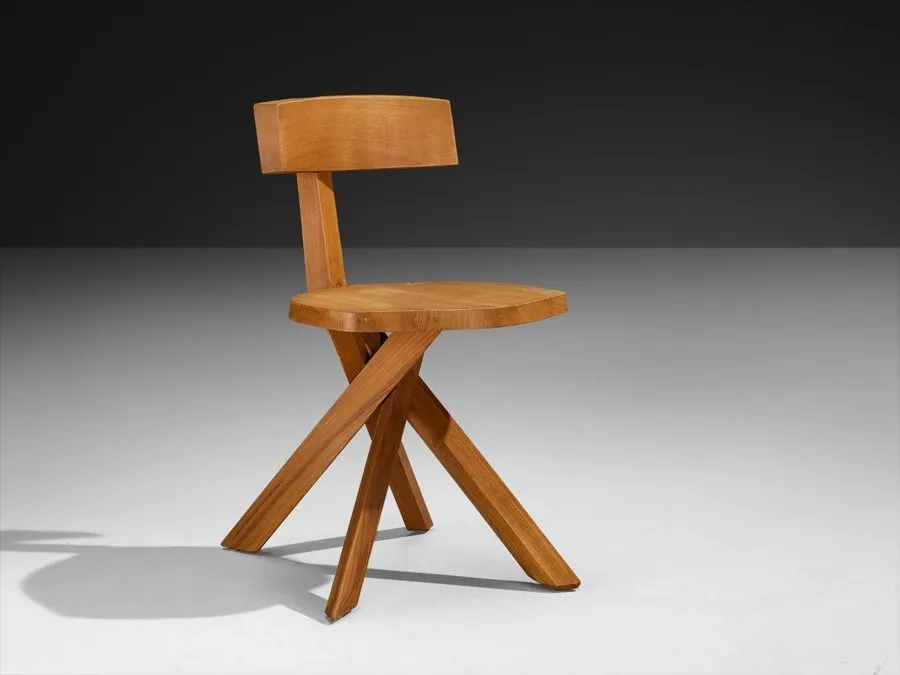 A wooden chair with a shaped back on splayed legs