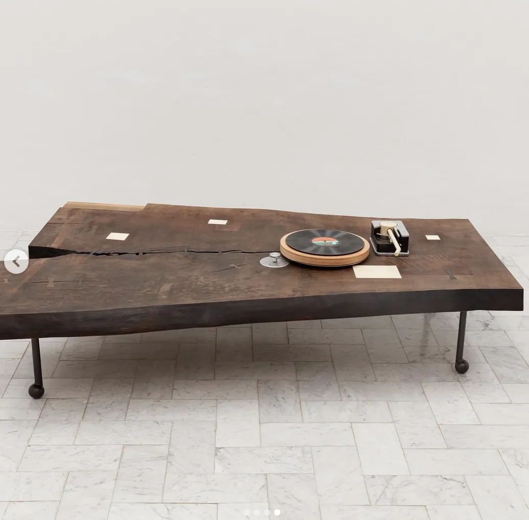 Dark wood table with visible contrasting butterfly joints crossing a natural split in the tabletop