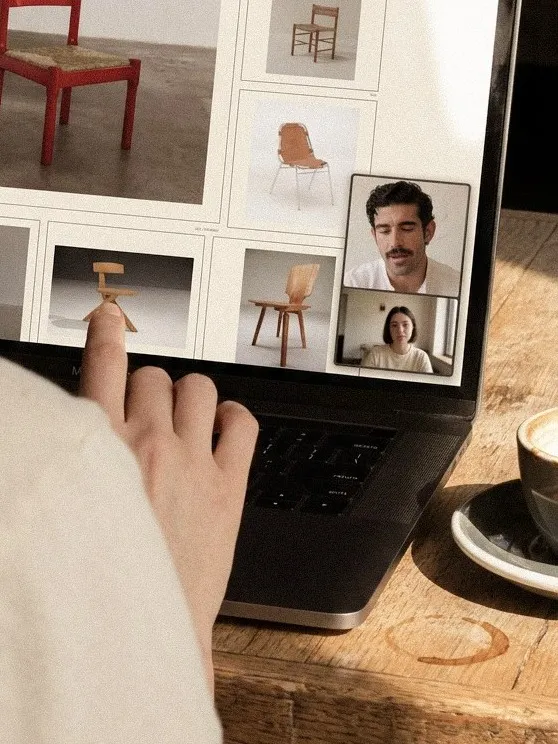 A tablet showing a sheet of chairs beside a video call with the designer