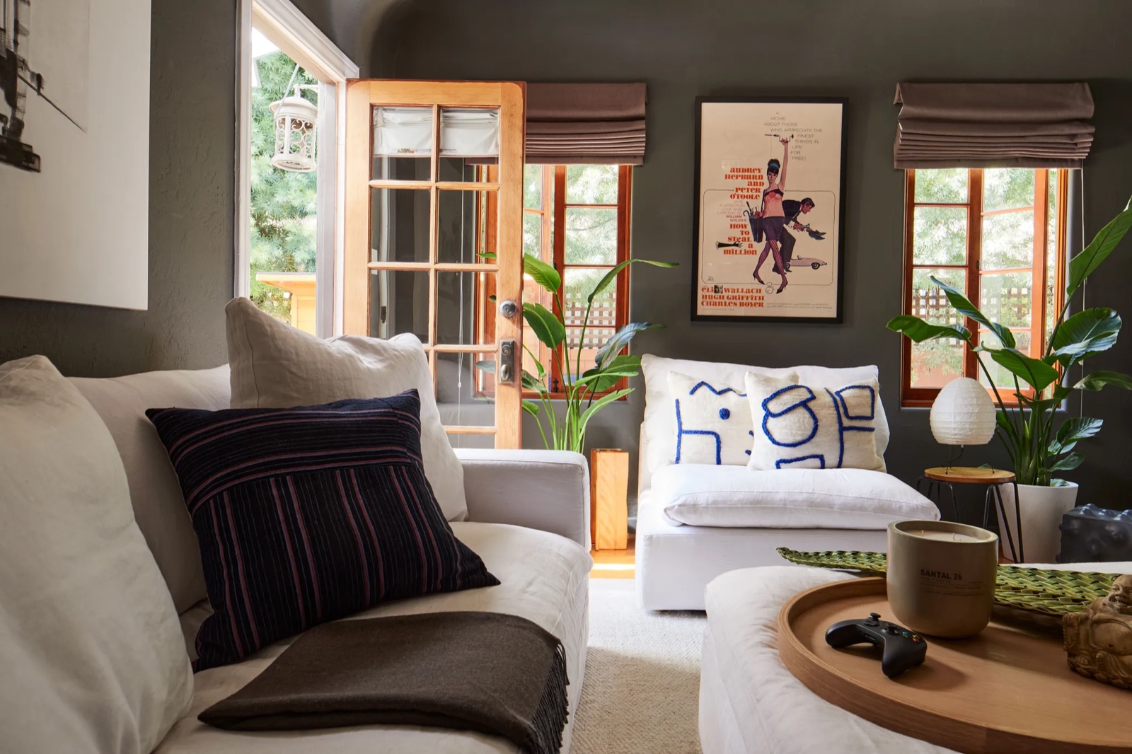 A living room with olive walls and French doors, a project by Charlie Barstein